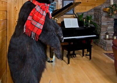 Godfrey Ranch piano and stuffed bear with santa hat and scarf