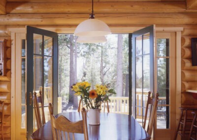 Auberry Mountain Ranch dining with open doors to deck