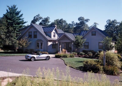 Exterior view of Mendon (8208) with white convertible parked in front of house
