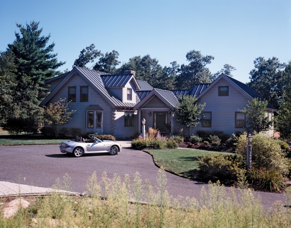 Exterior view of Mendon (8208) with white convertible parked in front of house