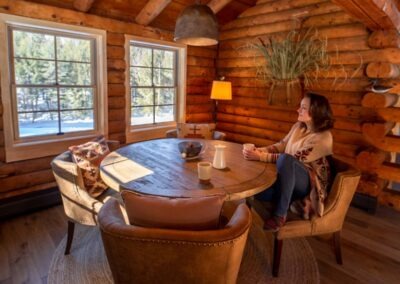 Greydon Cabin breakfast nook with woman sitting at small, circular table