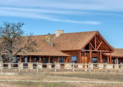 Rush Creek Ranch exterior photo with cattle drinking in the foreground.