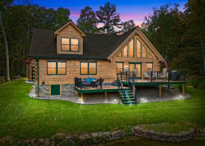 Spring Lake Log Home rear exterior at twilight featuring two back decks.